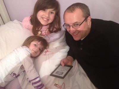 A family enjoy <i>The Troll Trap</i> on Kindle.