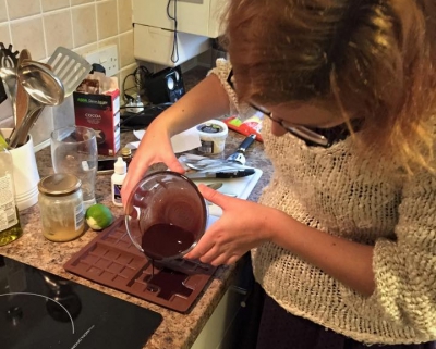 Pouring the chocolate into silicone bar moulds